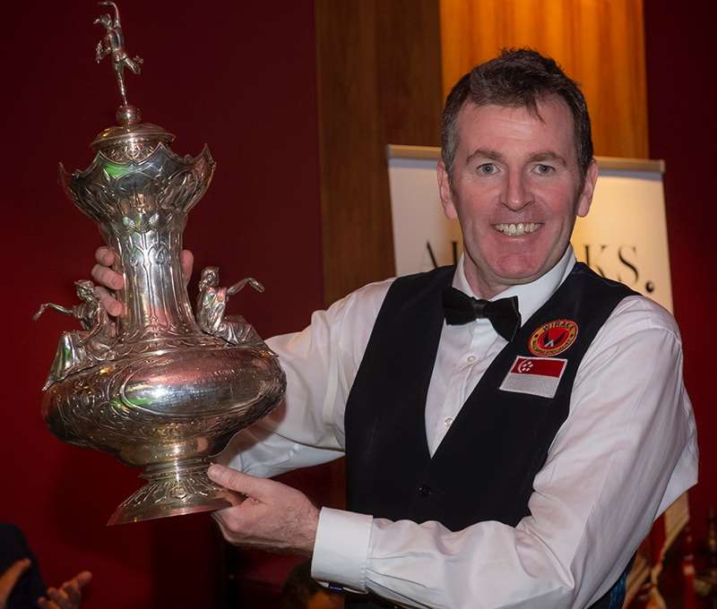 Peter Gilchrist lifts the John Roberts Trophy