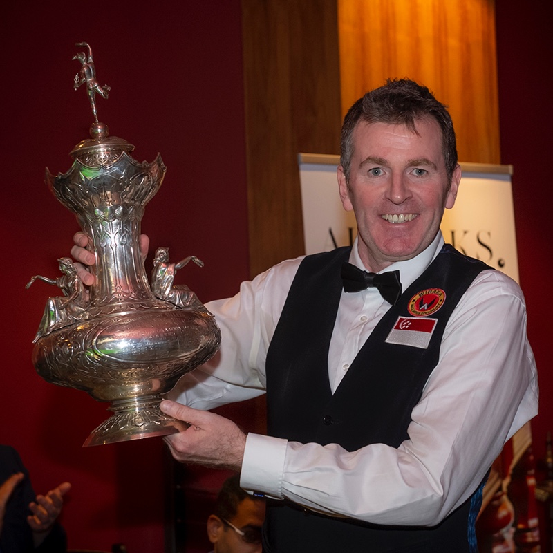 Peter Gilchrist lifts the John Roberts Trophy